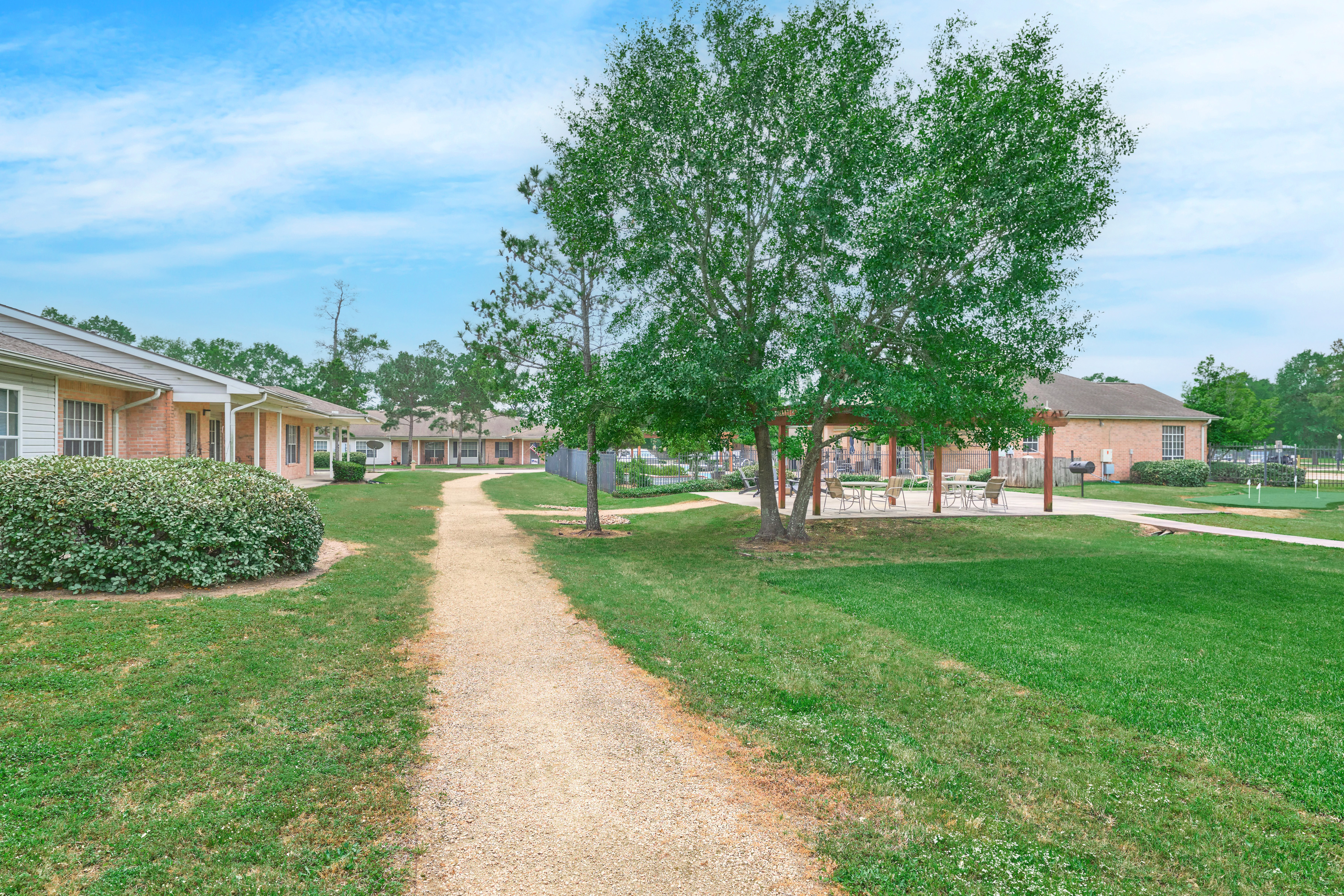 Walking path between cottages leading to covered seating and pool area at Oak Haven
